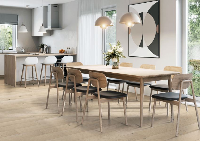 warm toned wood flooring in dining room with minimalist decor.